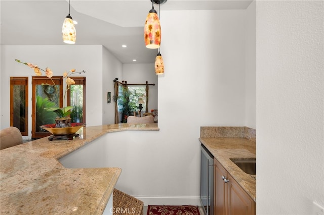 56102 Baltusrol Ln, Quinta, CA 92253 - kitchen featuring decorative light fixtures, light stone counters, and recessed lighting