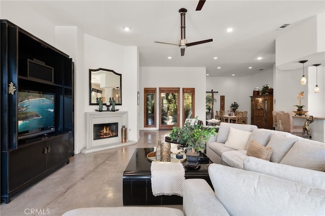 56102 Baltusrol Ln, Quinta, CA 92253 - living room featuring ceiling fan, finished concrete floors, a glass covered fireplace, and recessed lighting