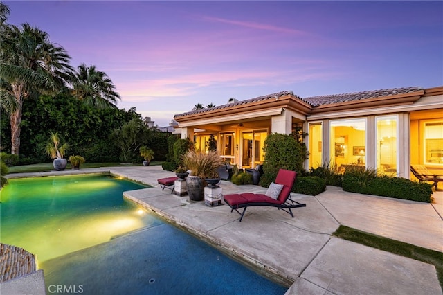 56102 Baltusrol Ln, Quinta, CA 92253 - back of house with a patio, a tile roof, and an outdoor pool