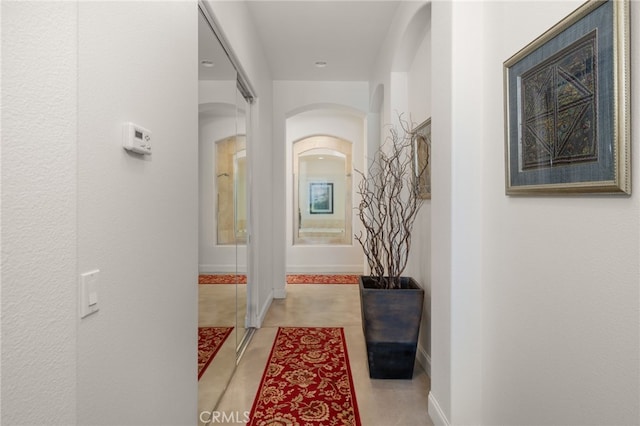 56102 Baltusrol Ln, Quinta, CA 92253 - corridor with arched walkways and tile patterned flooring