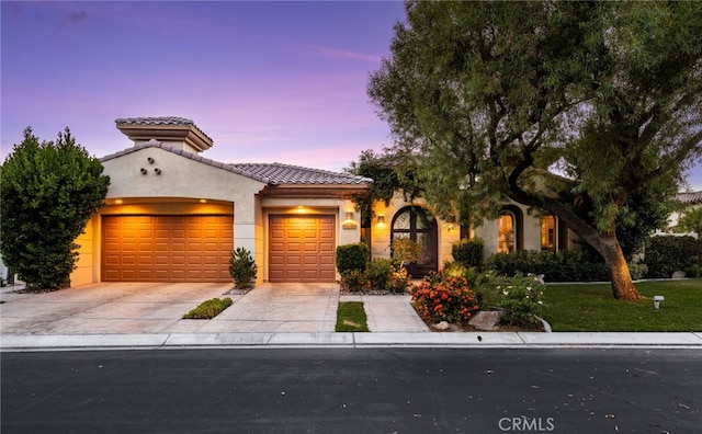 56102 Baltusrol Ln, Quinta, CA 92253 - mediterranean / spanish-style house with an attached garage, concrete driveway, stucco siding, and a tile roof