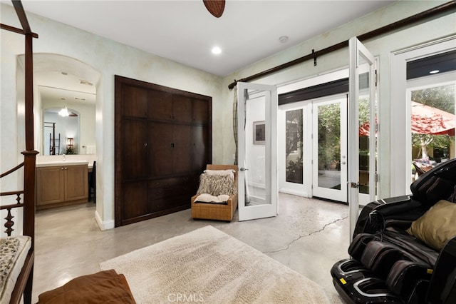 56102 Baltusrol Ln, Quinta, CA 92253 - living room with concrete floors, french doors, and a ceiling fan