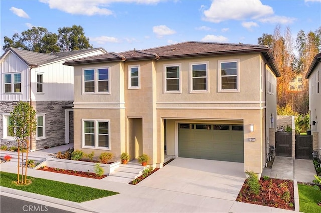 390 Riverbend, Lake Forest, CA 92630 - view of front facade featuring an attached garage, driveway, stone siding, and stucco siding