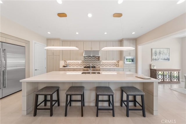 390 Riverbend, Lake Forest, CA 92630 - kitchen with built in appliances, under cabinet range hood, tasteful backsplash, light countertops, and a kitchen bar