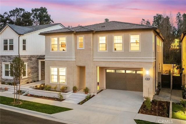 390 Riverbend, Lake Forest, CA 92630 - view of front of property featuring concrete driveway, an attached garage, stucco siding, and stone siding