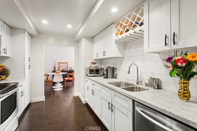 930 N Wetherly Dr Unit 201, West Hollywood, CA 90069 - kitchen featuring appliances with stainless steel finishes, tasteful backsplash, white cabinets, recessed lighting, and light stone counters