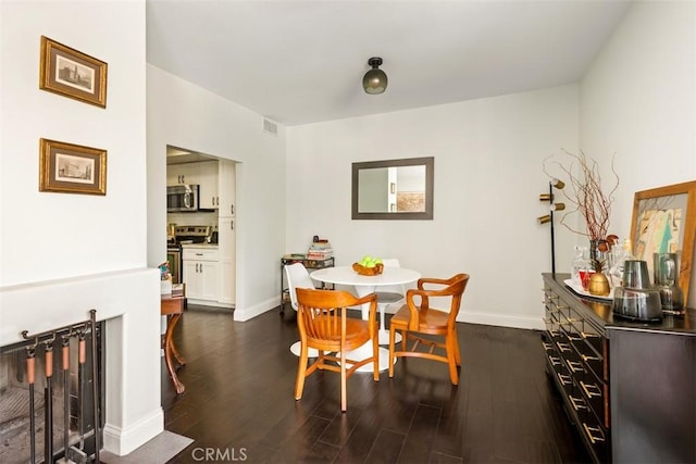 930 N Wetherly Dr Unit 201, West Hollywood, CA 90069 - dining area featuring dark wood-type flooring and baseboards