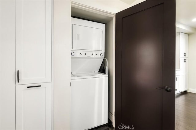 930 N Wetherly Dr Unit 201, West Hollywood, CA 90069 - laundry area featuring stacked washing machine and dryer and dark wood-style flooring