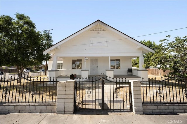594 W 10th St, San Bernardino, CA 92410 - bungalow-style house with a porch and a fenced front yard
