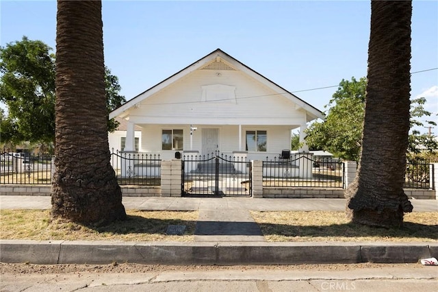 594 W 10th St, San Bernardino, CA 92410 - bungalow-style house with covered porch, a fenced front yard, and a gate