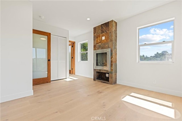 8280 Grand View Dr, Los Angeles, CA 90046 - unfurnished living room featuring a tiled fireplace, wood finished floors, and recessed lighting