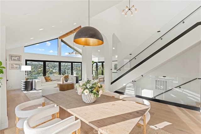 8280 Grand View Dr, Los Angeles, CA 90046 - dining room with high vaulted ceiling, wood finished floors, stairway, recessed lighting, and a chandelier