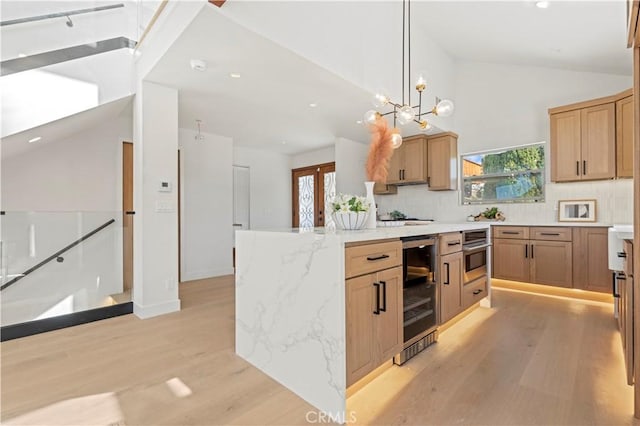 8280 Grand View Dr, Los Angeles, CA 90046 - kitchen featuring wine cooler, light wood-style flooring, recessed lighting, light stone counters, and hanging light fixtures