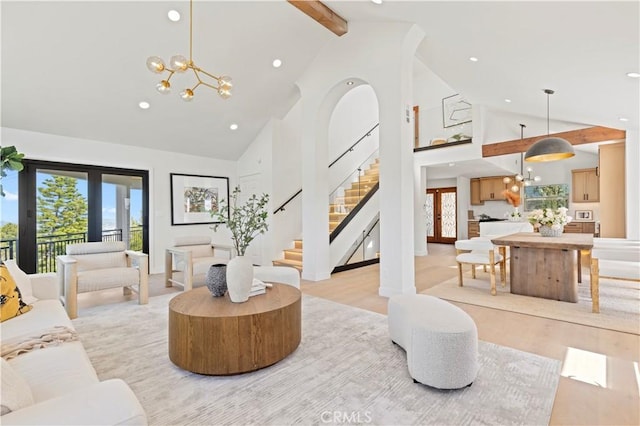 8280 Grand View Dr, Los Angeles, CA 90046 - living room with high vaulted ceiling, a chandelier, light wood finished floors, recessed lighting, and beam ceiling