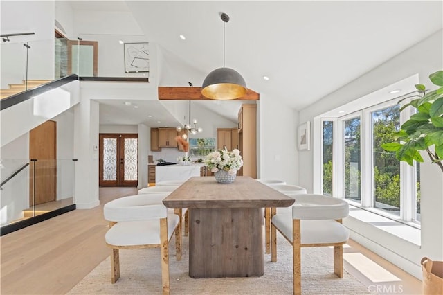 8280 Grand View Dr, Los Angeles, CA 90046 - dining room featuring light wood finished floors, vaulted ceiling, recessed lighting, and stairway