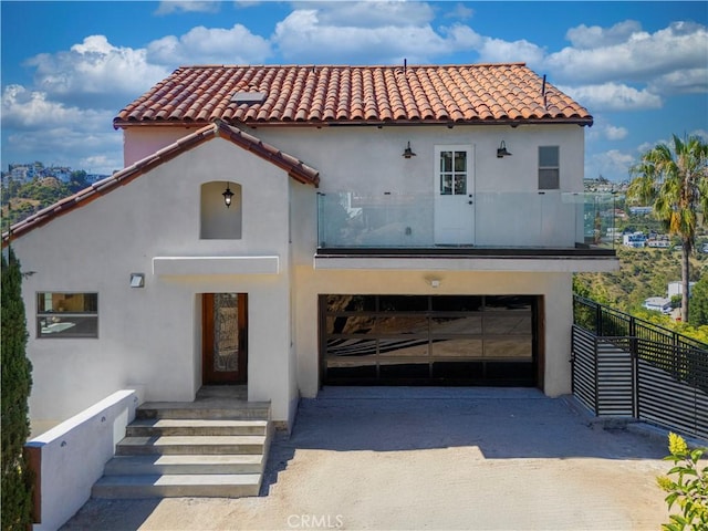 8280 Grand View Dr, Los Angeles, CA 90046 - mediterranean / spanish home featuring driveway, stucco siding, a tiled roof, and an attached garage