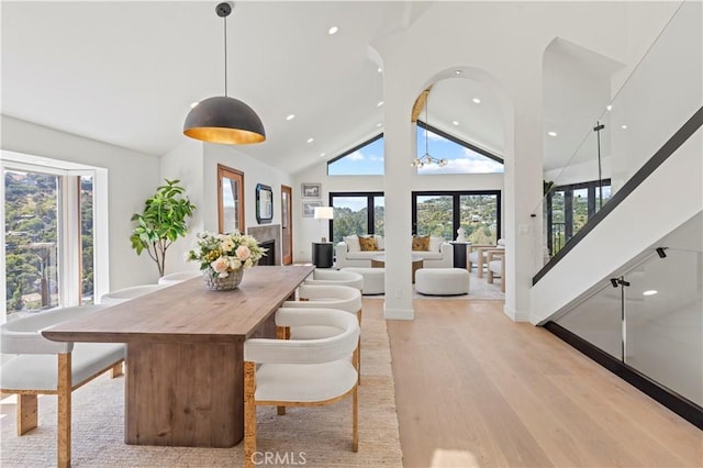 8280 Grand View Dr, Los Angeles, CA 90046 - dining area with plenty of natural light, light wood finished floors, recessed lighting, stairs, and high vaulted ceiling