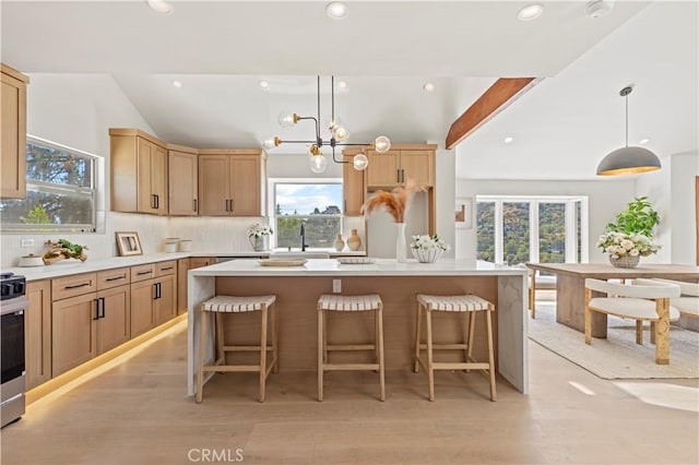 8280 Grand View Dr, Los Angeles, CA 90046 - kitchen featuring plenty of natural light, backsplash, a kitchen bar, light countertops, and recessed lighting