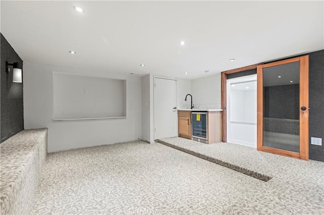 8280 Grand View Dr, Los Angeles, CA 90046 - unfurnished living room featuring beverage cooler, bar with sink, carpet flooring, and recessed lighting