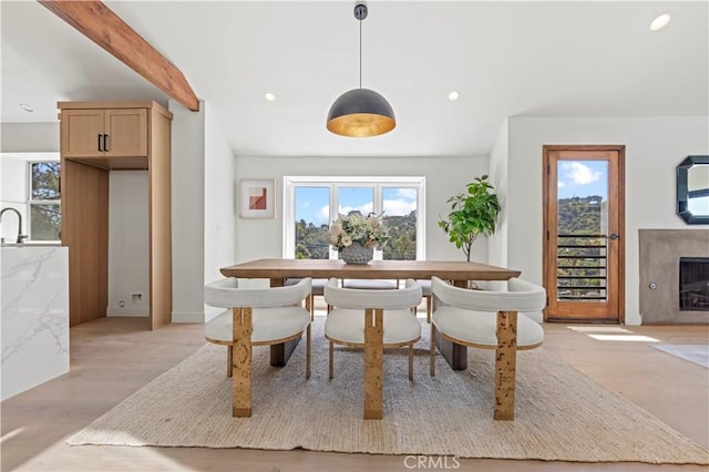 8280 Grand View Dr, Los Angeles, CA 90046 - dining space featuring healthy amount of natural light, recessed lighting, a fireplace, light wood-style flooring, and beamed ceiling