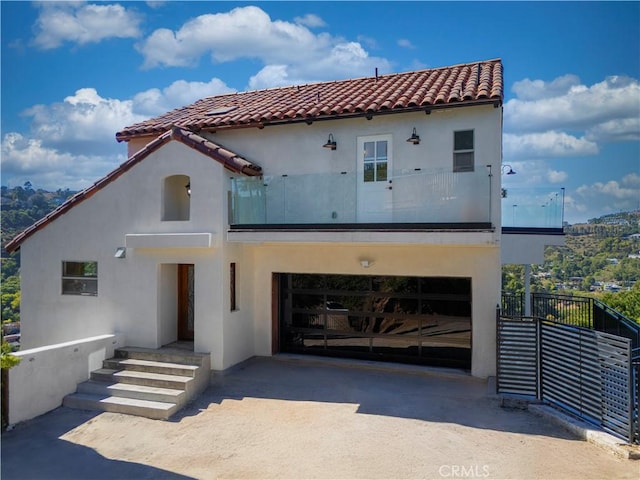 8280 Grand View Dr, Los Angeles, CA 90046 - mediterranean / spanish-style home with stucco siding, a tiled roof, concrete driveway, and an attached garage