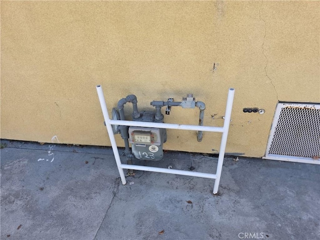 123 E Gage Ave, Los Angeles, CA 90003 - exterior view of stucco siding and gas meter