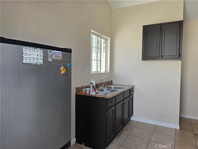 123 E Gage Ave, Los Angeles, CA 90003 - kitchen featuring freestanding refrigerator and light tile patterned flooring
