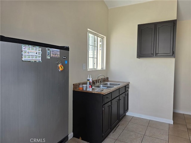 123 E Gage Ave, Los Angeles, CA 90003 - kitchen with refrigerator and light tile patterned floors