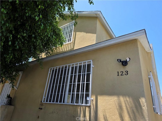 123 E Gage Ave, Los Angeles, CA 90003 - view of property exterior with stucco siding