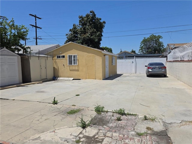 123 E Gage Ave, Los Angeles, CA 90003 - view of side of property with a storage shed and a patio