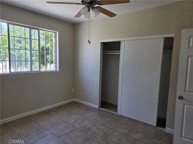 123 E Gage Ave, Los Angeles, CA 90003 - unfurnished bedroom featuring a closet, tile patterned floors, and a ceiling fan