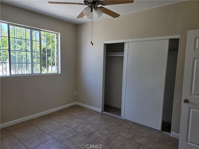 123 E Gage Ave, Los Angeles, CA 90003 - unfurnished bedroom featuring a closet, tile patterned flooring, and ceiling fan