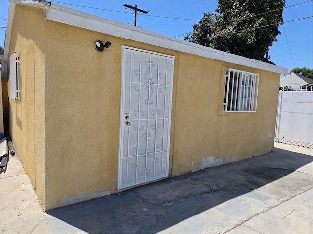 123 E Gage Ave, Los Angeles, CA 90003 - entrance to property featuring stucco siding and a patio area