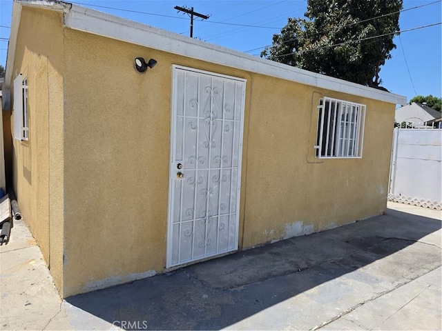 123 E Gage Ave, Los Angeles, CA 90003 - property entrance with stucco siding and a patio
