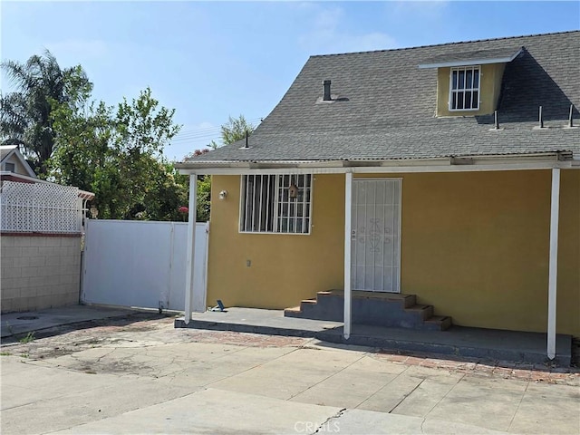 123 E Gage Ave, Los Angeles, CA 90003 - back of house with roof with shingles, stucco siding, and entry steps