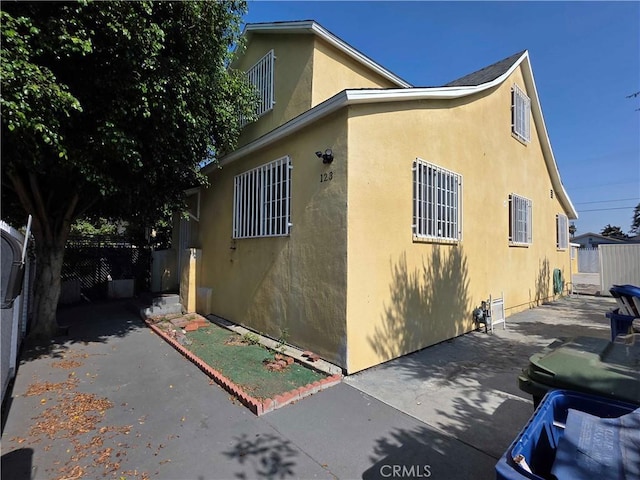 123 E Gage Ave, Los Angeles, CA 90003 - view of property exterior with stucco siding and a patio