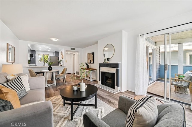 628 Daisy Ave Unit 316, Long Beach, CA 90802 - living area with wood finished floors and a fireplace with flush hearth