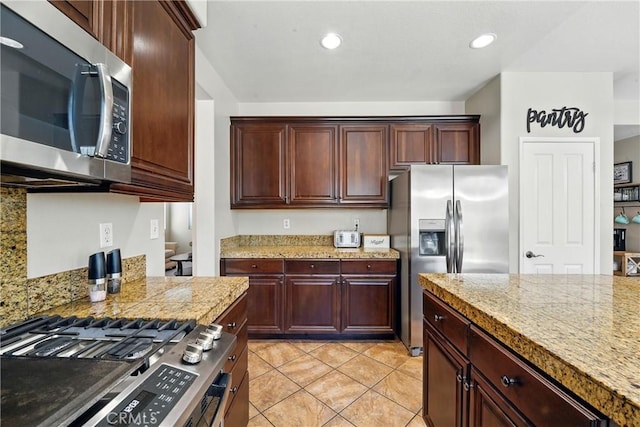 31258 Shadow Ridge Dr, Menifee, CA 92584 - kitchen with stainless steel appliances, light tile patterned floors, tile counters, and recessed lighting