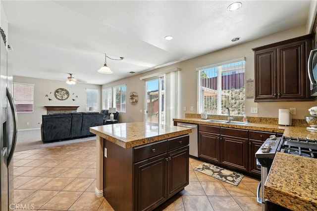 31258 Shadow Ridge Dr, Menifee, CA 92584 - kitchen with stainless steel appliances, tile counters, a center island, dark brown cabinets, and recessed lighting