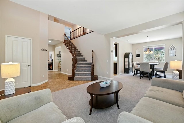 31258 Shadow Ridge Dr, Menifee, CA 92584 - living room featuring stairs, a chandelier, and light colored carpet