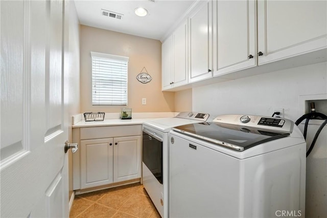 31258 Shadow Ridge Dr, Menifee, CA 92584 - washroom with independent washer and dryer, light tile patterned flooring, and cabinet space