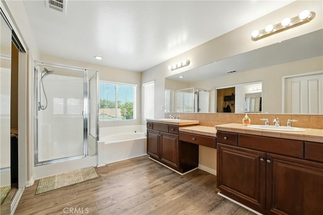 31258 Shadow Ridge Dr, Menifee, CA 92584 - full bath with a shower stall, double vanity, a bath, wood finished floors, and a spacious closet