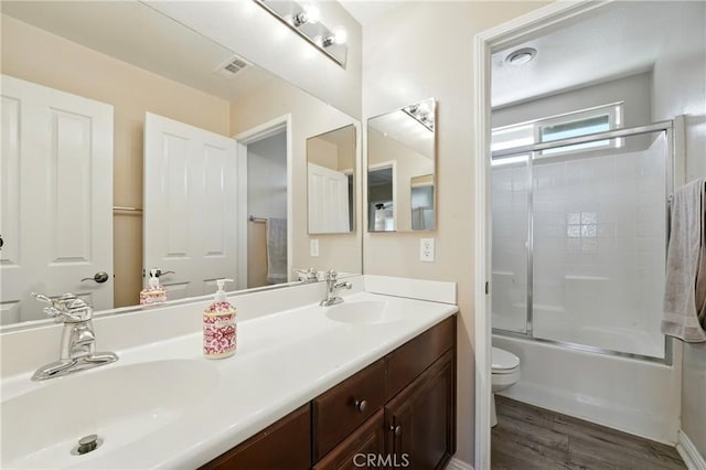 31258 Shadow Ridge Dr, Menifee, CA 92584 - bathroom featuring double vanity, wood finished floors, and bath / shower combo with glass door