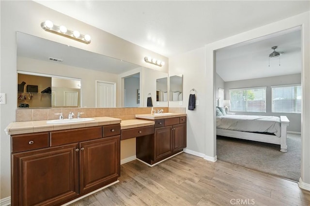 31258 Shadow Ridge Dr, Menifee, CA 92584 - ensuite bathroom featuring double vanity, wood finished floors, and decorative backsplash