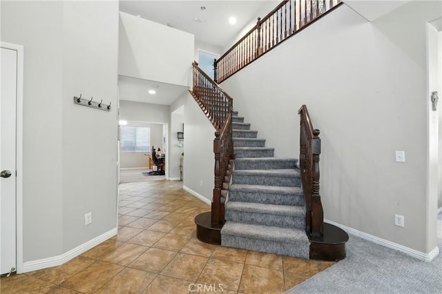 31258 Shadow Ridge Dr, Menifee, CA 92584 - staircase with tile patterned flooring, recessed lighting, and a high ceiling