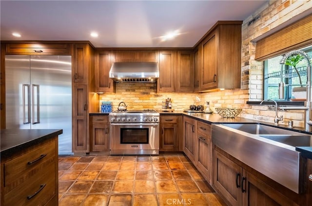1960 Polaris Dr, Glendale, CA 91208 - kitchen with premium appliances, wall chimney exhaust hood, dark countertops, and decorative backsplash