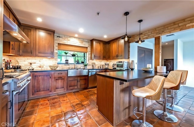 1960 Polaris Dr, Glendale, CA 91208 - kitchen featuring appliances with stainless steel finishes, range hood, dark countertops, backsplash, and a kitchen bar