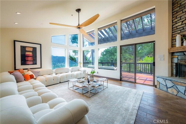 1960 Polaris Dr, Glendale, CA 91208 - living room featuring plenty of natural light, hardwood / wood-style floors, a stone fireplace, a towering ceiling, and recessed lighting