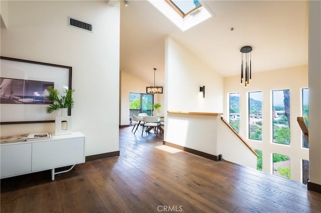 1960 Polaris Dr, Glendale, CA 91208 - corridor featuring healthy amount of natural light, high vaulted ceiling, dark wood-style floors, a chandelier, and a skylight