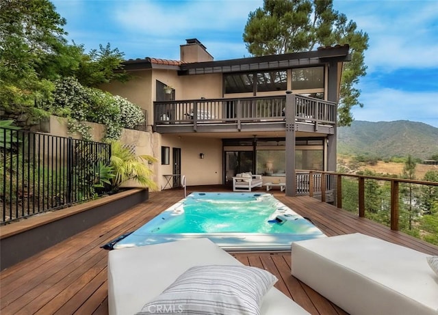 1960 Polaris Dr, Glendale, CA 91208 - rear view of house featuring a balcony, stucco siding, outdoor lounge area, and a deck with mountain view